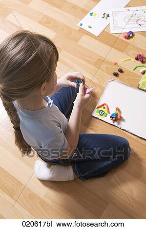 young girl playing with modelling clay View Large Photo Image Stock Image - young girl playing with modelling clay. Fotosearch