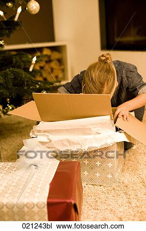 young girl unpacking present on christmas eve View Large Photo Image Stock Image - young girl unpacking present on christmas eve. Fotosearch