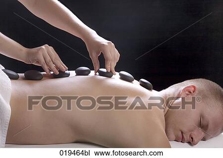 young man getting hot stone massage treatment View Large Photo Image Stock Image - young man getting hot stone massage treatment. Fotosearch