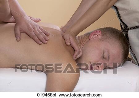 young man getting massage treatment View Large Photo Image Stock Image - young man getting massage treatment. Fotosearch