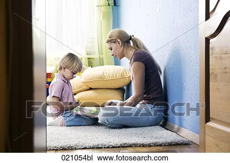 young mother and her son reading book together View Large Photo Image Stock Image - young mother and her son reading book together. Fotosearch