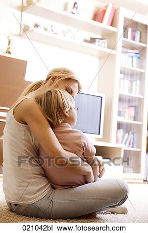 young mother and her son sitting on floor in living room View Large Photo Image Stock Image - young mother and her son sitting on floor in living room. Fotosearch