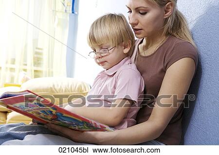 young mother reading from book to her son View Large Photo Image Stock Image - young mother reading from book to her son. Fotosearch
