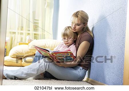 young mother reading from book to her son View Large Photo Image Stock Image - young mother reading from book to her son. Fotosearch