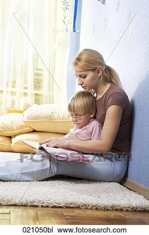 young mother reading from book to her son View Large Photo Image Stock Image - young mother reading from book to her son. Fotosearch