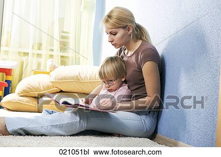 young mother reading from book to her son View Large Photo Image Stock Image - young mother reading from book to her son. Fotosearch
