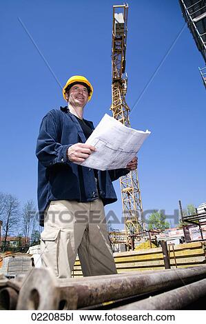 architect with blueprint on construction site View Large Photo Image Stock Image - architect with blueprint on construction site. Fotosearch
