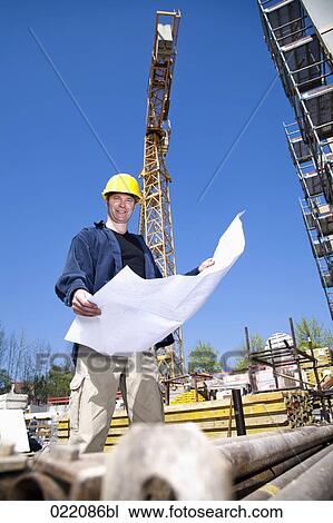 architect with blueprint on construction site View Large Photo Image Stock Image - architect with blueprint on construction site. Fotosearch