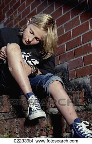 blond boy checking his injured leg View Large Photo Image Stock Image - blond boy checking his injured leg. Fotosearch