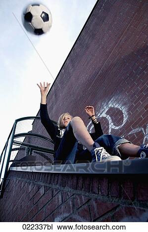 blond boy sitting on stairway throwing football View Large Photo Image Stock Image - blond boy sitting on stairway throwing football. Fotosearch