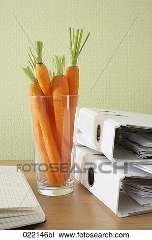 carrots in glass on office desk View Large Photo Image Stock Image - carrots in glass on office desk. Fotosearch