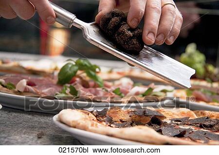 close-up of chef rasping truffle over pizza View Large Photo Image Stock Image - close-up of chef rasping truffle over pizza. Fotosearch