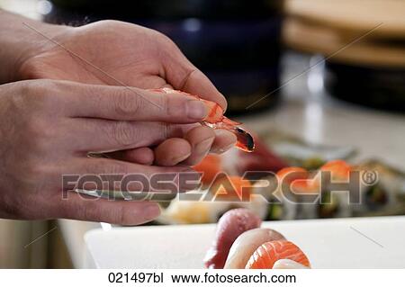 Stock Image - close-up of japanese chef making sushi. Fotosearch