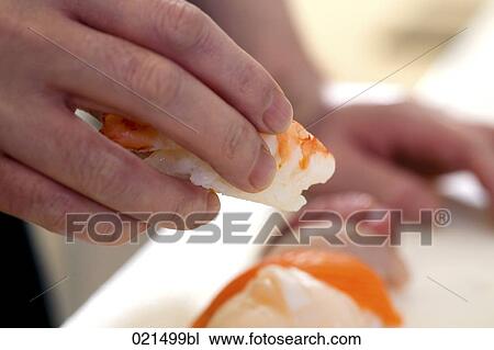 Stock Image - close-up of japanese chef making sushi. Fotosearch