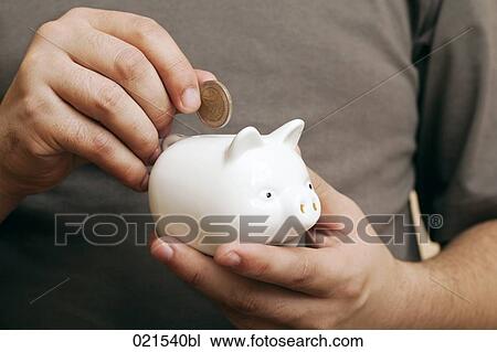 close-up of man putting coin into piggybank View Large Photo Image Stock Image - close-up of man putting coin into piggybank. Fotosearch