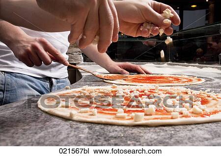 close-up of pizza bakers preparing pizzas View Large Photo Image Stock Image - close-up of pizza bakers preparing pizzas. Fotosearch