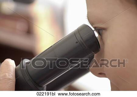 close-up of woman looking through microscope View Large Photo Image Stock Image - close-up of woman looking through microscope. Fotosearch