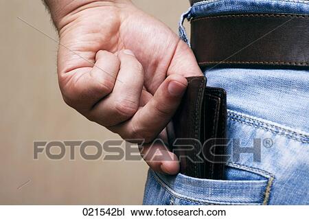 Stock Image - close-up of young man pulling wallet out of trouser pocket. Fotosearch