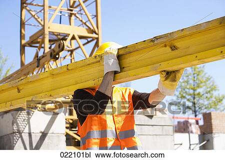 construction worker carrying wooden plank View Large Photo Image Stock Image - construction worker carrying wooden plank. Fotosearch