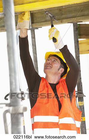 Stock Image - construction worker using hammer. Fotosearch