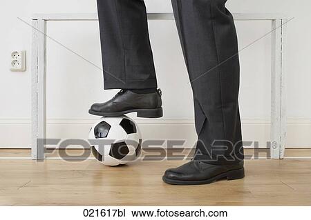 Stock Image - detail of businessman standing in front of goal at home. Fotosearch