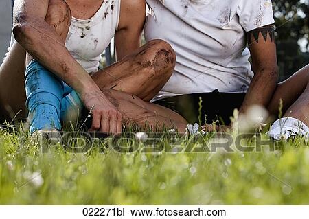 detail of two women in football dresses sitting in grass View Large Photo Image Stock Image - detail of two women in football dresses sitting in grass. Fotosearch
