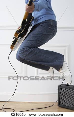 detail of woman playing electric guitar at home View Large Photo Image Stock Image - detail of woman playing electric guitar at home. Fotosearch