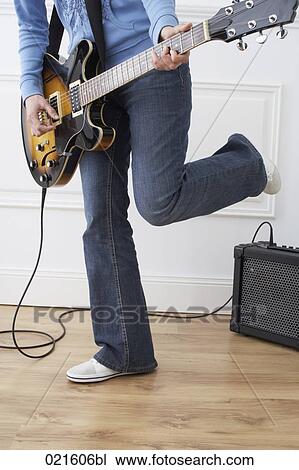 detail of woman playing electric guitar at home View Large Photo Image Stock Image - detail of woman playing electric guitar at home. Fotosearch