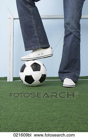 Stock Image - detail of woman standing on football. Fotosearch