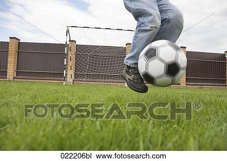 detail of young boy playing football View Large Photo Image Stock Image - detail of young boy playing football. Fotosearch