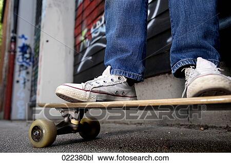 detail of young boy standing on skateboard View Large Photo Image Stock Image - detail of young boy standing on skateboard. Fotosearch