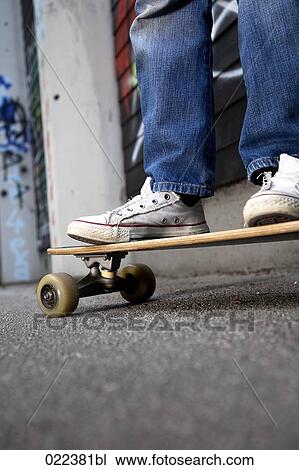 detail of young boy standing on skateboard View Large Photo Image Stock Image - detail of young boy standing on skateboard. Fotosearch