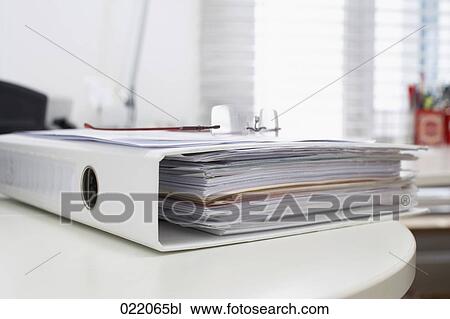 Stock Image - file and glasses lying on table. Fotosearch