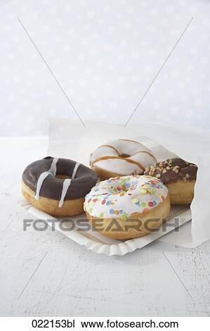 four different donuts pouring out of paper bag View Large Photo Image Stock Image - four different donuts pouring out of paper bag. Fotosearch