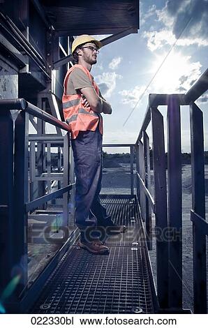 Stock Image - full body portrait of worker with high visibility clothing. Fotosearch