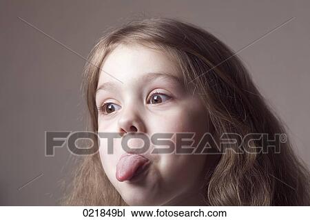headshot of young girl sticking out tongue View Large Photo Image Stock Image - headshot of young girl sticking out tongue. Fotosearch