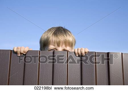 little boy trying to look over fence View Large Photo Image Stock Image - little boy trying to look over fence. Fotosearch