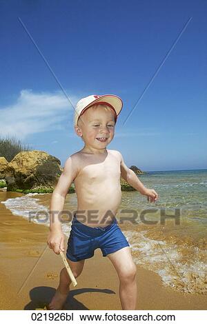 little boy wearing cap running along beach View Large Photo Image Stock Image - little boy wearing cap running along beach. Fotosearch