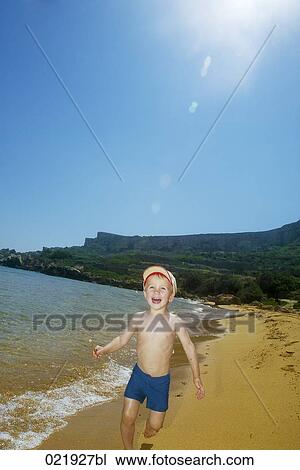 little boy wearing cap running along beach View Large Photo Image Stock Image - little boy wearing cap running along beach. Fotosearch