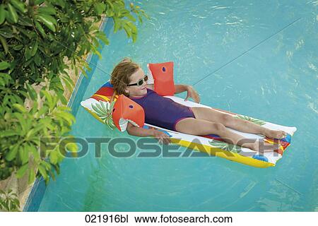 little girl lying on airbed floating in swimming pool View Large Photo Image Stock Image - little girl lying on airbed floating in swimming pool. Fotosearch