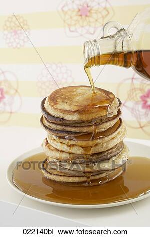 maple syrup being poured over pancakes View Large Photo Image Stock Image - maple syrup being poured over pancakes. Fotosearch