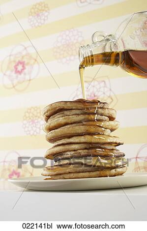 maple syrup being poured over pancakes View Large Photo Image Stock Image - maple syrup being poured over pancakes. Fotosearch