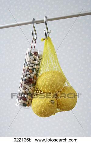 medical capsules and lemons hanging on hook View Large Photo Image Stock Image - medical capsules and lemons hanging on hook. Fotosearch