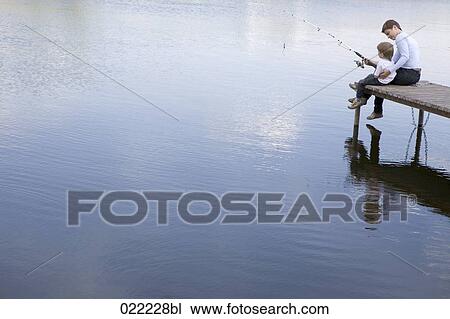 mother and young son sitting on pier fishing together View Large Photo Image Stock Image - mother and young son sitting on pier fishing together. Fotosearch