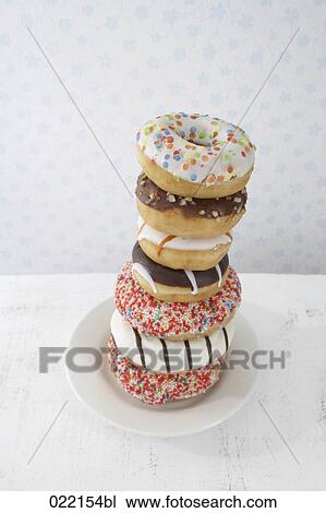 pile of donuts on plate View Large Photo Image Stock Image - pile of donuts on plate. Fotosearch