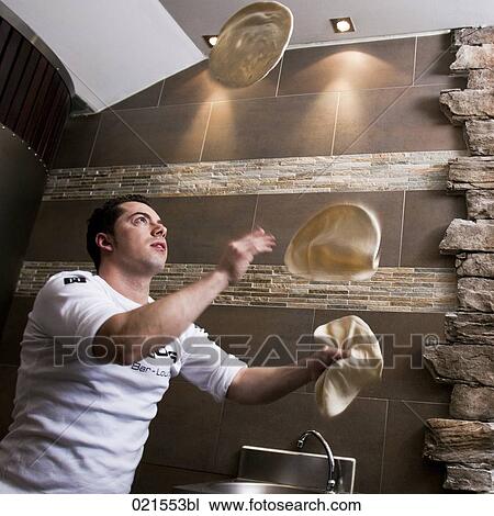 pizza baker juggling with dough View Large Photo Image Stock Image - pizza baker juggling with dough. Fotosearch