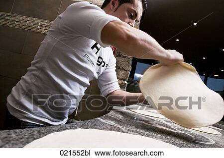 Stock Image - pizza baker making dough. Fotosearch
