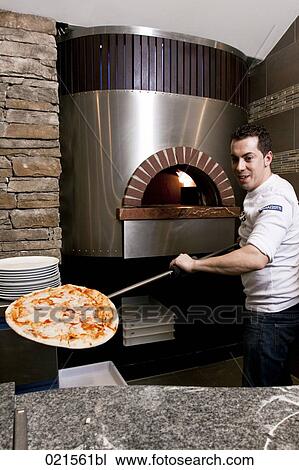 pizza baker serving pizza fresh from the oven View Large Photo Image Stock Image - pizza baker serving pizza fresh from the oven. Fotosearch