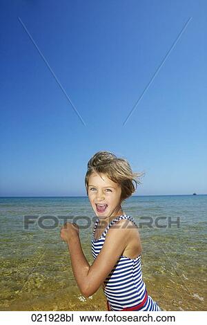 portait of little girl running along beach View Large Photo Image Stock Image - portait of little girl running along beach. Fotosearch