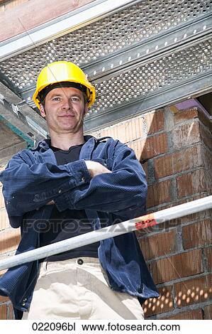 portrait of construction worker standing on scaffolding View Large Photo Image Stock Image - portrait of construction worker standing on scaffolding. Fotosearch